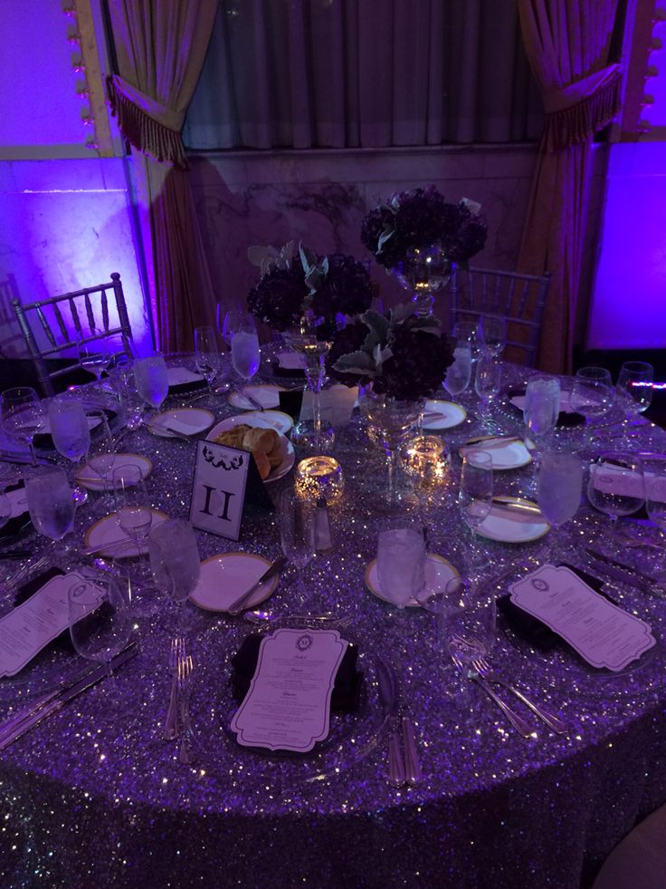 the table is set with silverware and place settings