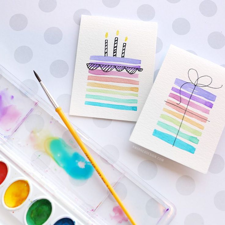 an artist's palette with watercolors and cards