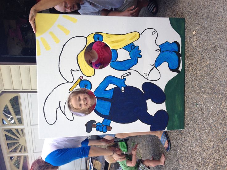 two children are standing next to a large painting on the ground with their hands in each other's pockets