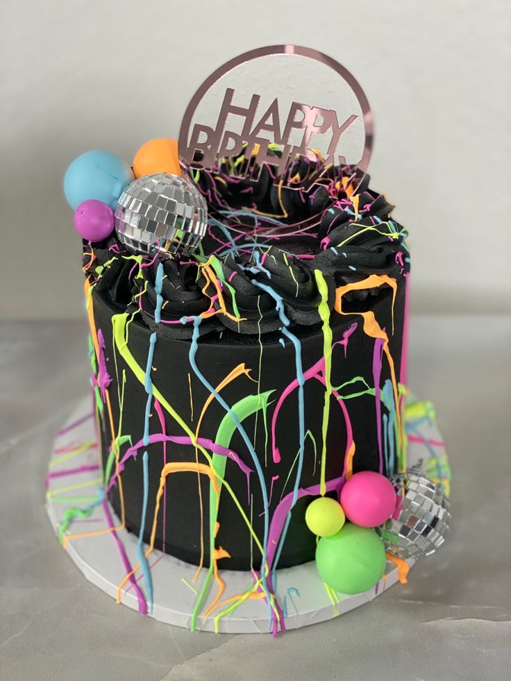 a birthday cake decorated with balloons and streamers