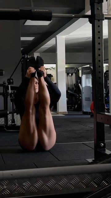 a person sitting on the ground in a gym