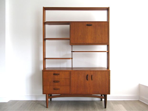 a wooden shelf with two drawers and a cabinet on it's side, against a white wall