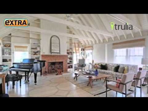 a living room filled with furniture and a piano in the middle of it's floor