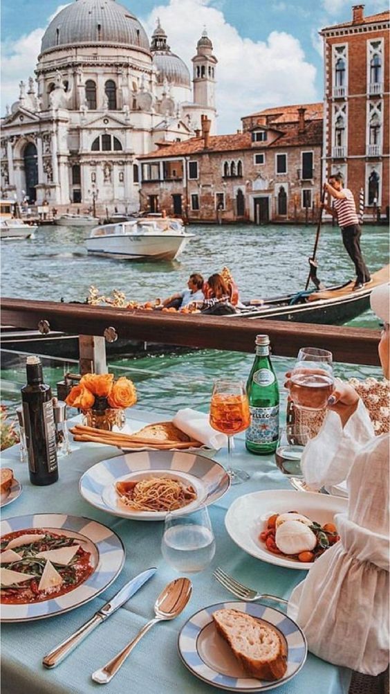 a gondola boat is in the water with food on it and people eating