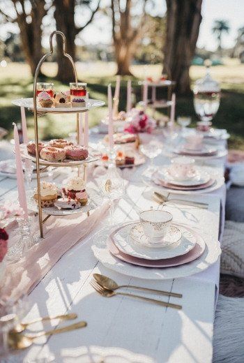 a long table with plates and cups on it