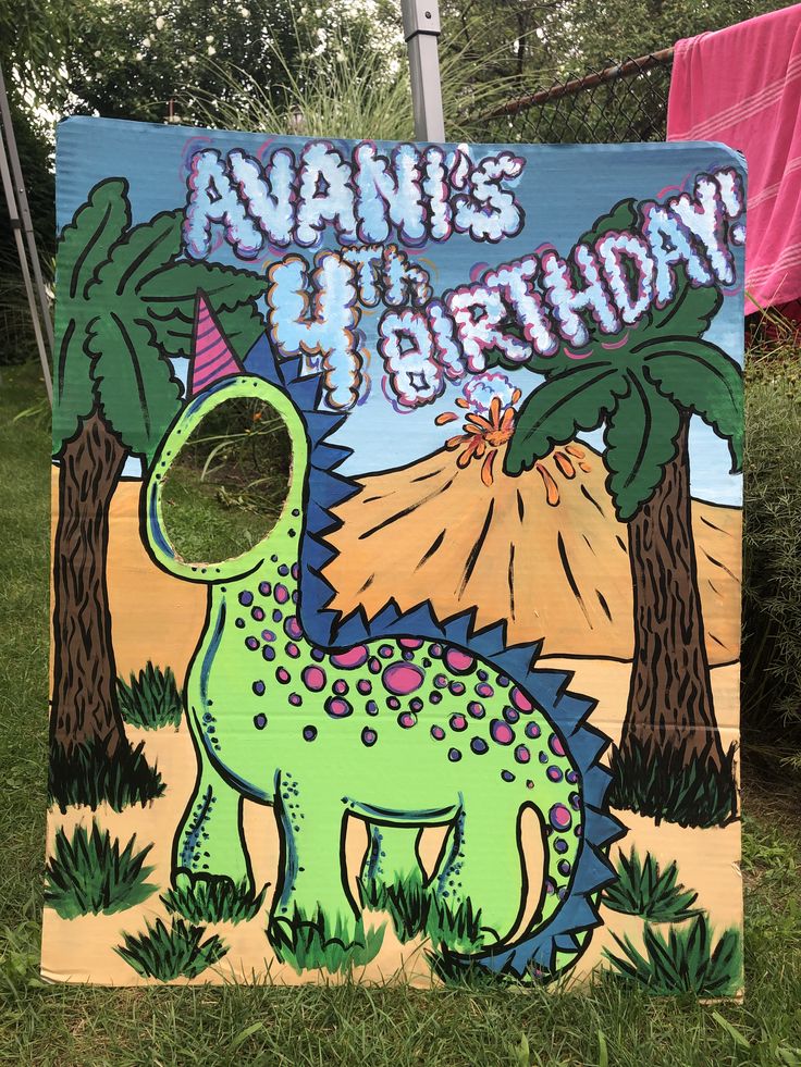 a dinosaur birthday sign in the grass