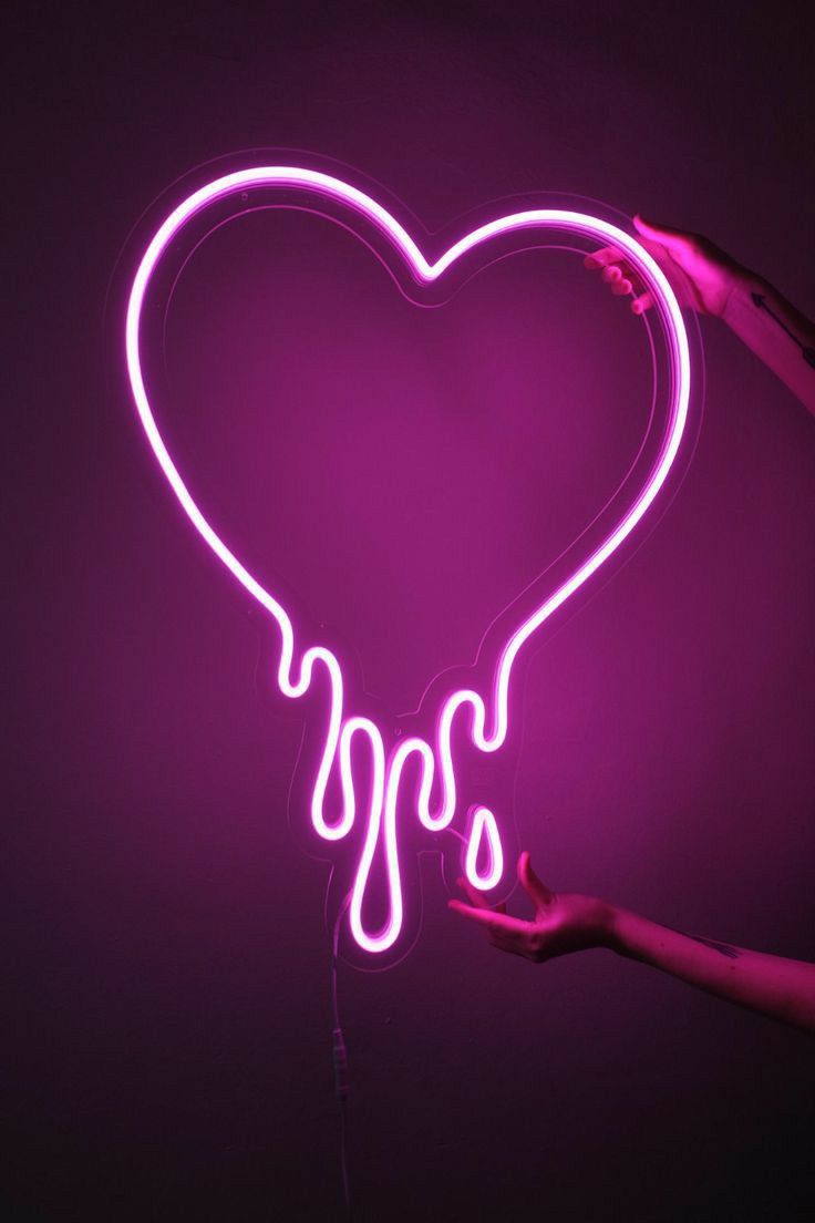 a heart shaped neon sign with dripping liquid