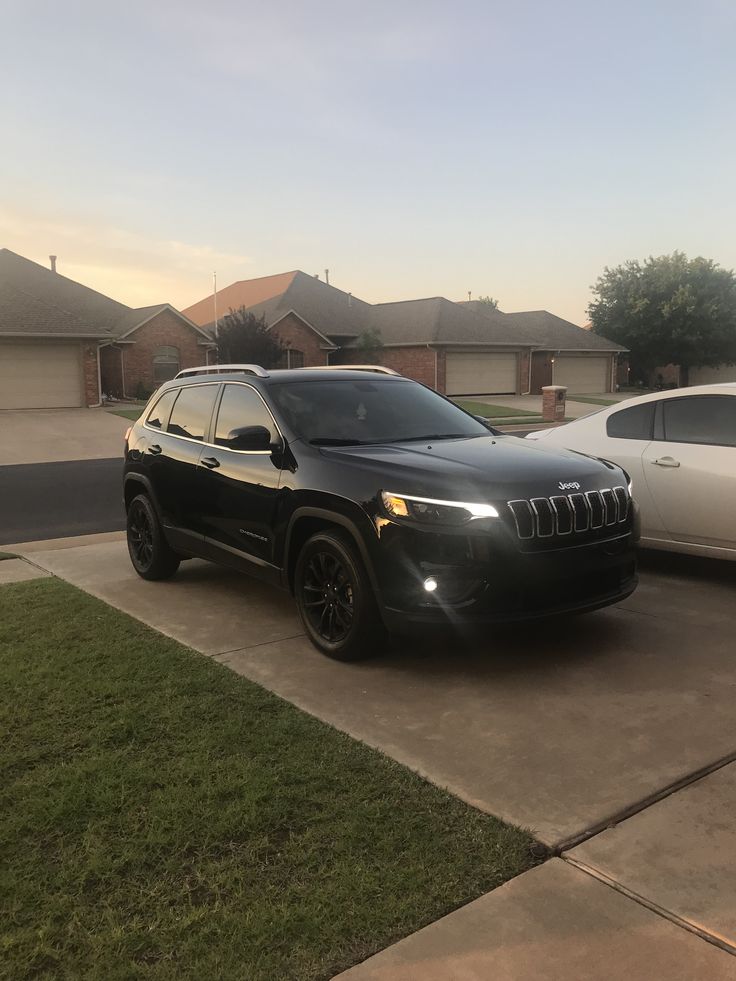 two cars parked in front of a house