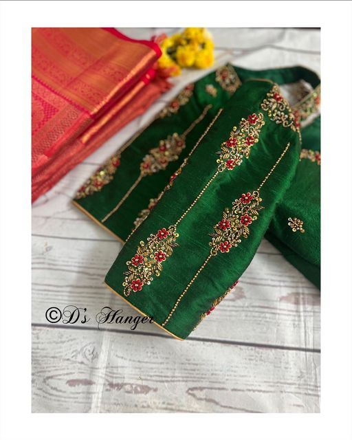 green and red saree with gold work on the border, along with yellow flowers