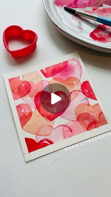 Mana on Instagram: "Happy Sunday to everyone! Here is my cookie cutter painting tutorial ! This is a very simple and easy watercolor painting! Great for Valentine’s Day card! 🥰💘 🎨What you need -Watercolor paint -Watercolor paper ( I measured 4x4 and there was extra space for the masking tape) -Masking tape or wash tape -cookie cutter (plastic one works better for me) -paper towel -clean water 1: Dip the cookie cutter in the paint and stamp it on the paper 💡If you get too much paint on the cutter, use paper towel or brush to take extra paint off! If you couldn’t stamp well, you might need to add more paint 🎨 and make sure you mix with water really well! 💡Practice stamping on the scrap paper and see how your cookie cutter works on the paper!! 2:Rinse your brush and apply very li Paintings On Paper Easy, What To Paint With Watercolor Easy, How To Use Water Colours, Card Making Watercolor, Easy Paintings Watercolor Simple, Simple Cards Handmade Less Is More, Diy I Love You Cards, Simple Watercolor Paintings Ideas Easy, Watercolor Hearts Painting