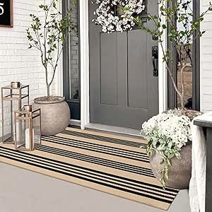 the front door is decorated with white flowers and potted plants, along with a welcome mat