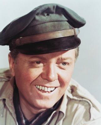 a man wearing a hat and smiling at the camera