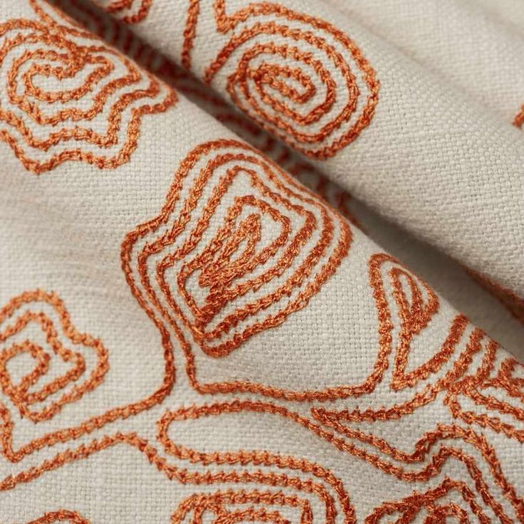 an orange and white pattern on fabric