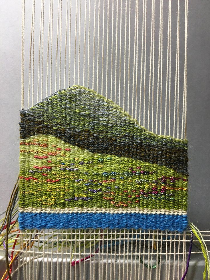 a close up of a weaving machine with yarn