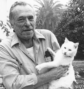 an old man holding a white cat in his arms