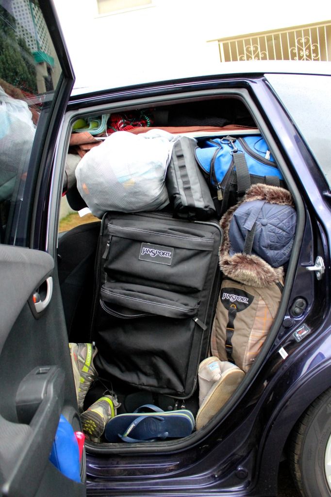 an open car door with luggage in the back