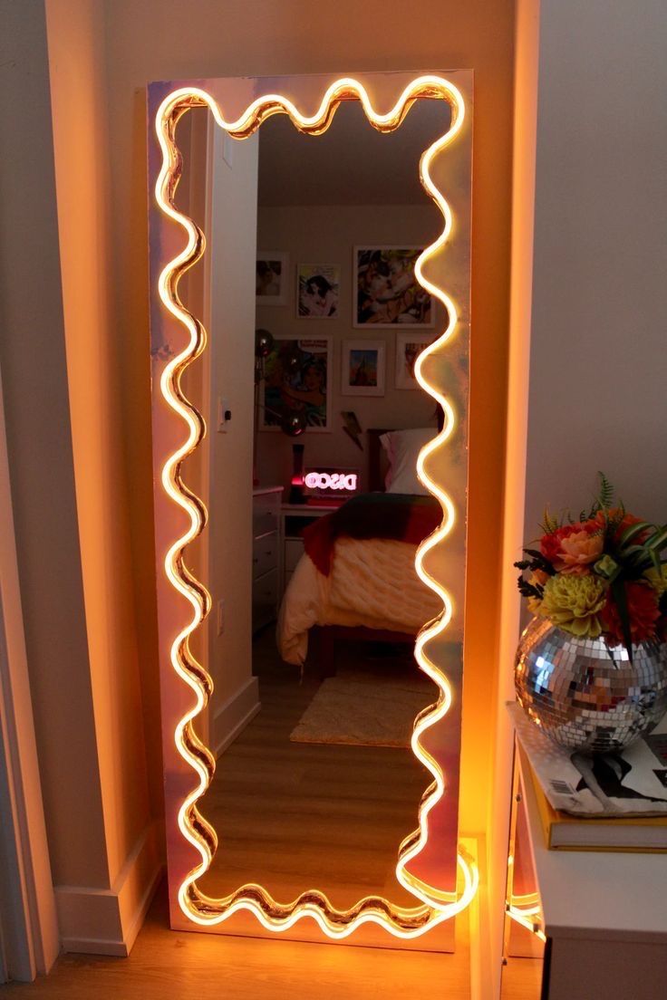 an illuminated mirror in the corner of a room