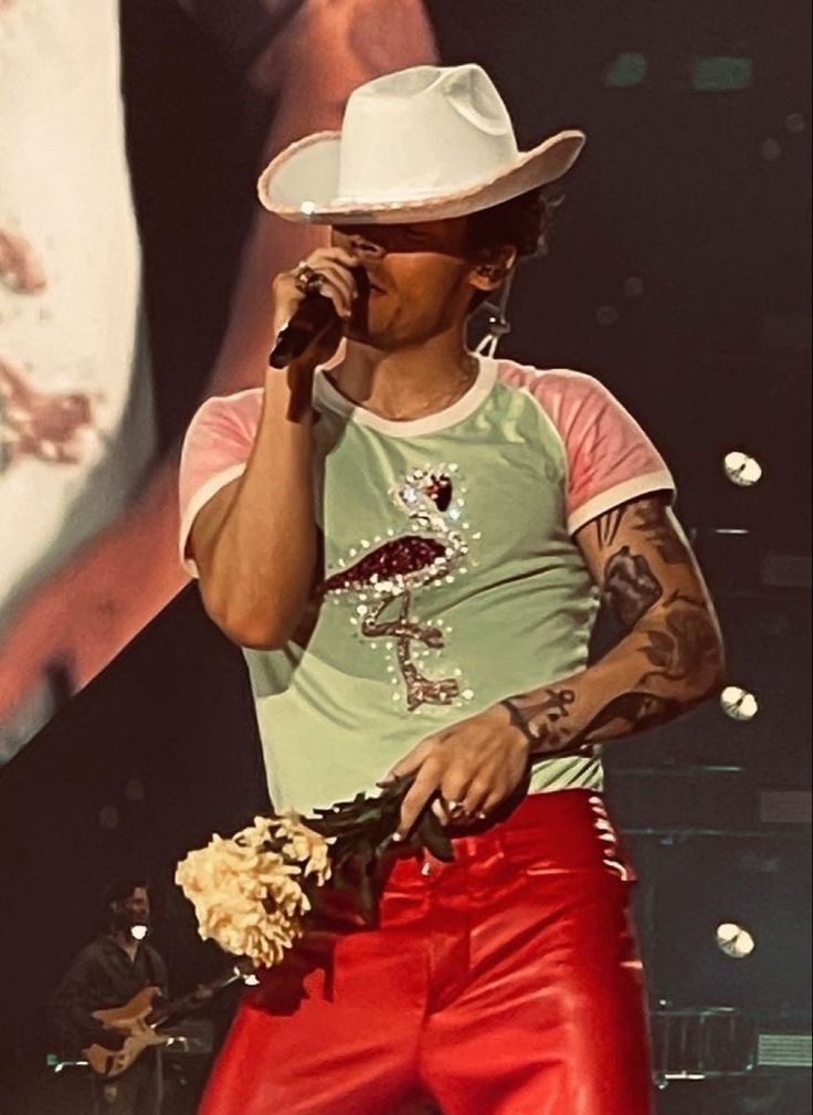 a male in a white hat and some red pants