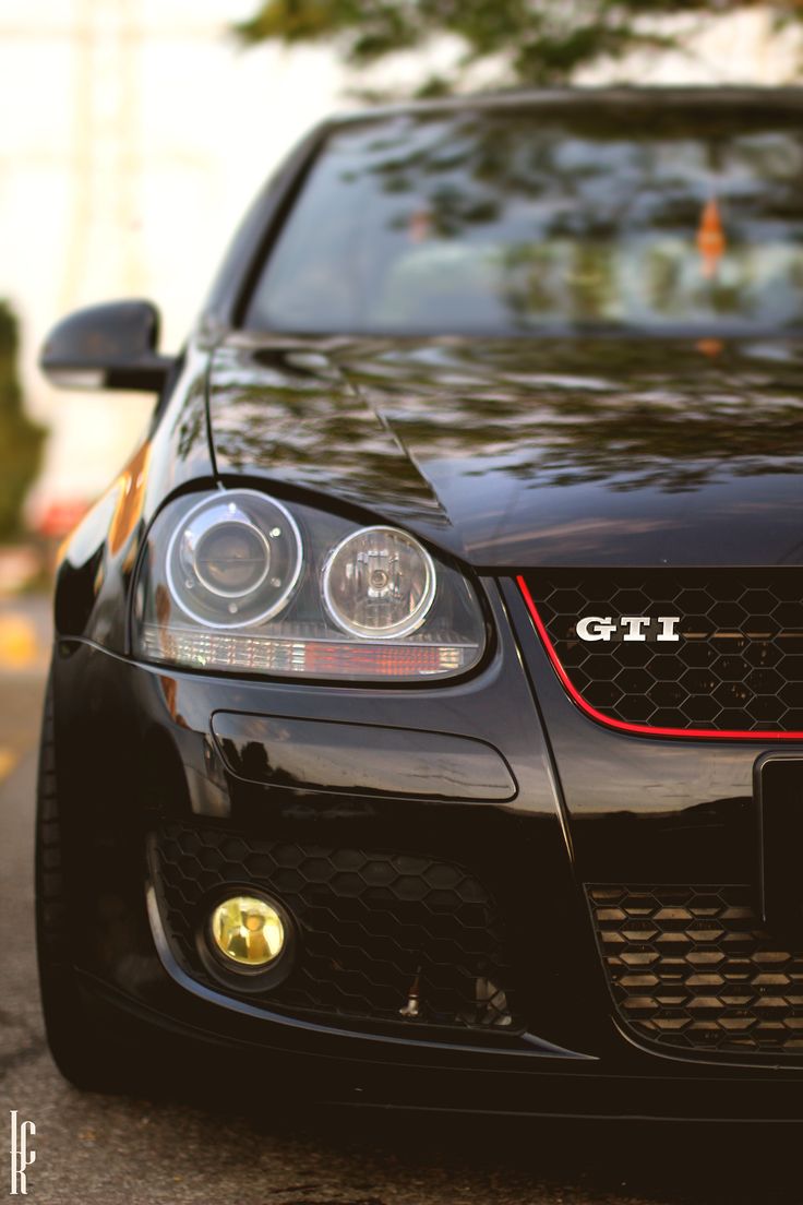 the front end of a black sports car