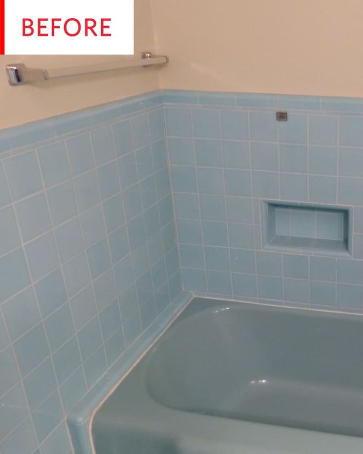 a bathroom with blue tiles and a bathtub next to the wall that has been painted white