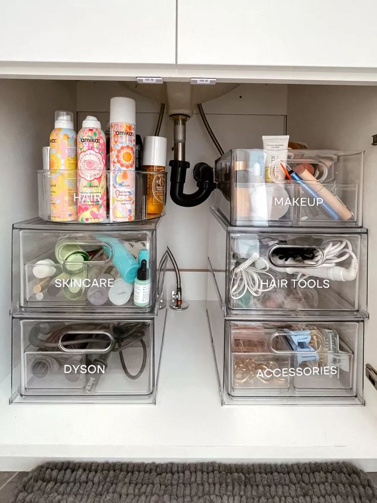 the drawers are organized with clear containers for makeup and hair care products, including hand sanitizers