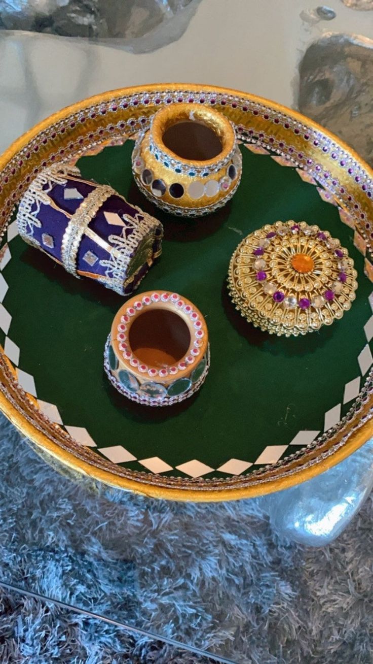 an elaborately decorated platter with two cups and other decorative items on it's tray