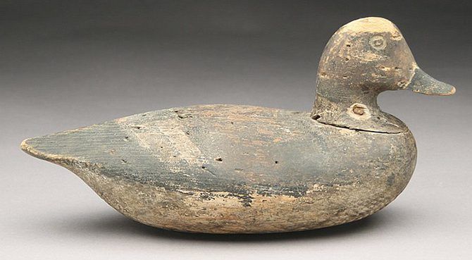 an old wooden duck toy sitting on top of a table