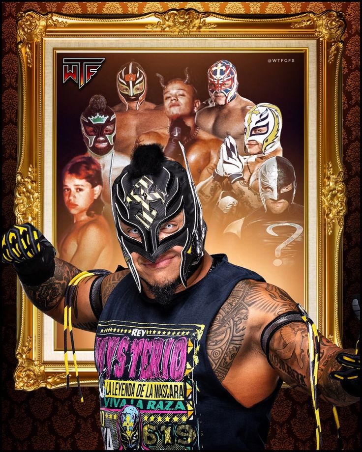 the wrestler is posing for a photo in front of a gold frame with his arms out