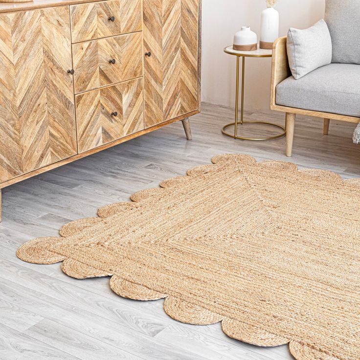 a living room with wooden furniture and rugs on the floor next to a dresser