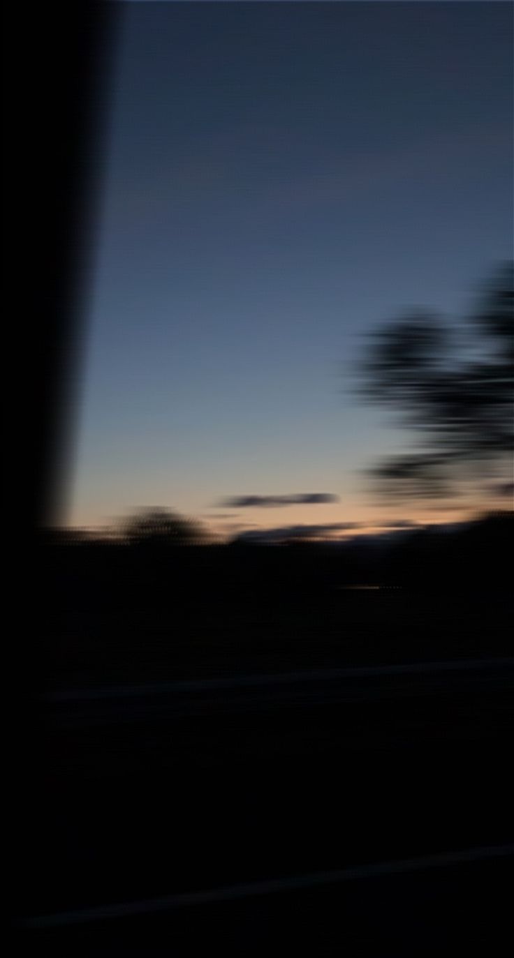 Deeply contrasted scenery view with orange and pink hues in the sky and blurry trees Blurry Sky Photos, Blurry Moon Aesthetic, Blurry Aesthetic Background, Blurry Sunset Aesthetic, Blurry Car Aesthetic, Blurry Lights Aesthetic, Blurry Background Aesthetic, Blurry Pictures Aesthetic, Draw Torso
