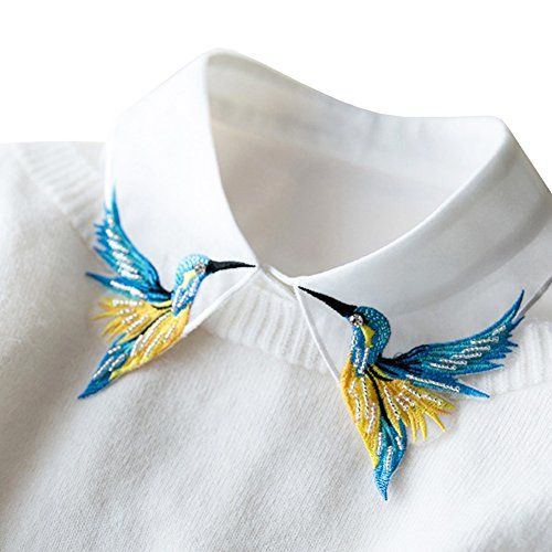 a white shirt with blue and yellow birds on it's collar is seen in this image