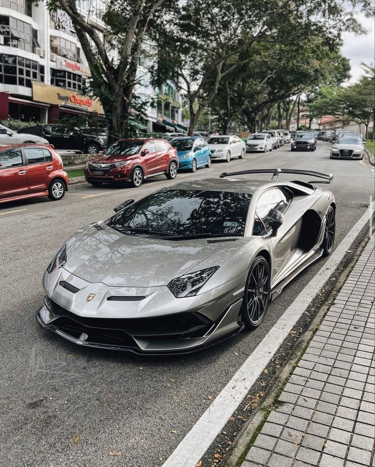 a silver sports car is parked on the street