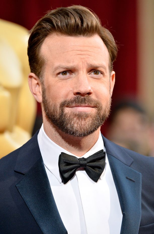 a man with a beard wearing a suit and bow tie