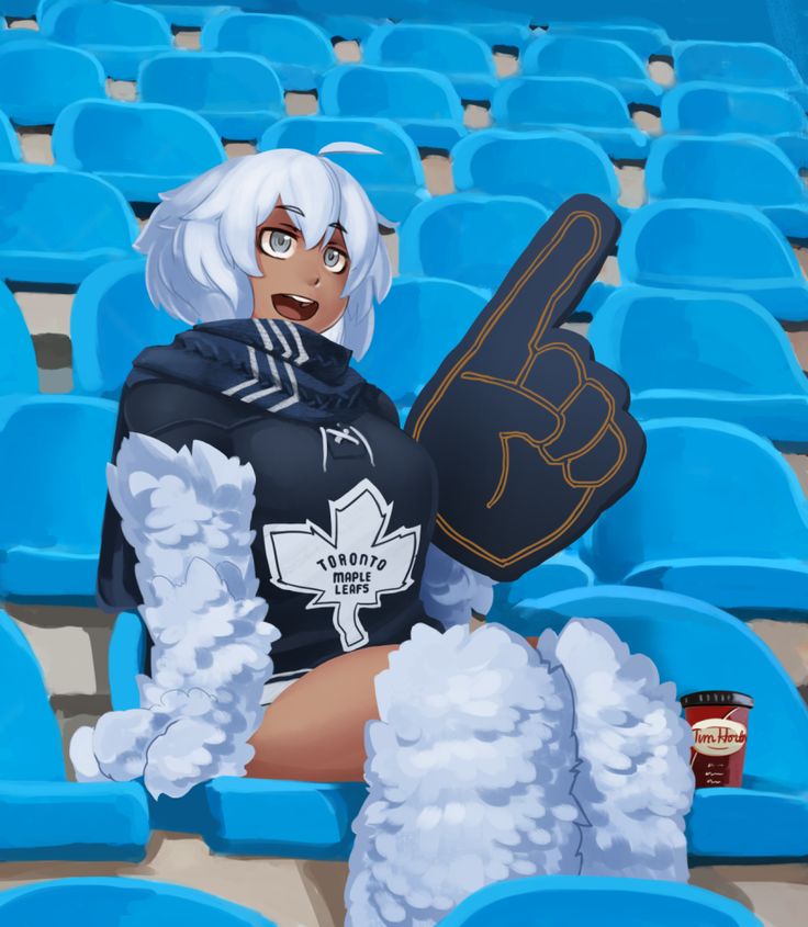 a woman sitting in the bleachers holding up a sign with her right hand