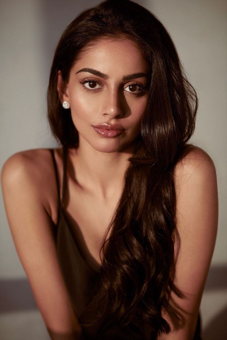 a woman with long brown hair posing for a photo