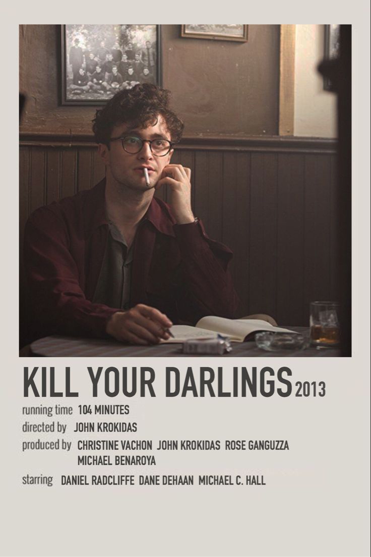 a man sitting at a table with a book in front of him and the words kill your darlings 2013 written on it