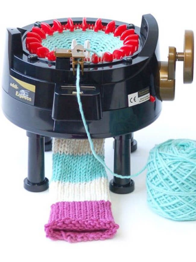 a ball of yarn sitting on top of a machine next to it's spools