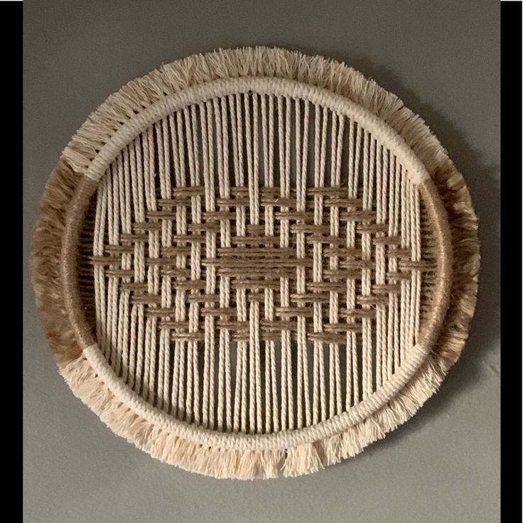 a woven basket hanging on the wall