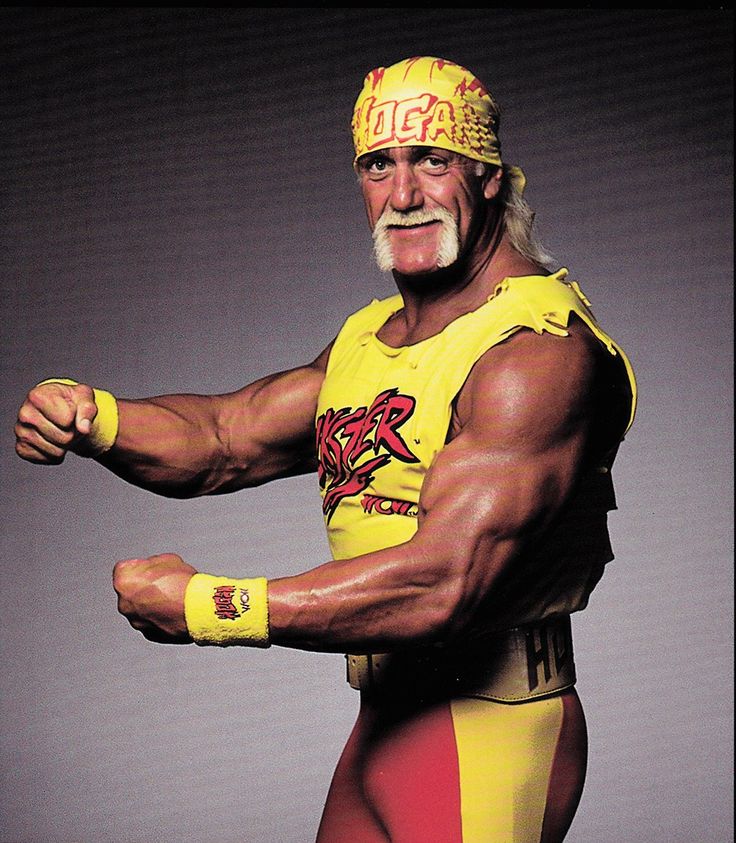 an old man in yellow wrestling gear posing for a photo with his hands on his hips