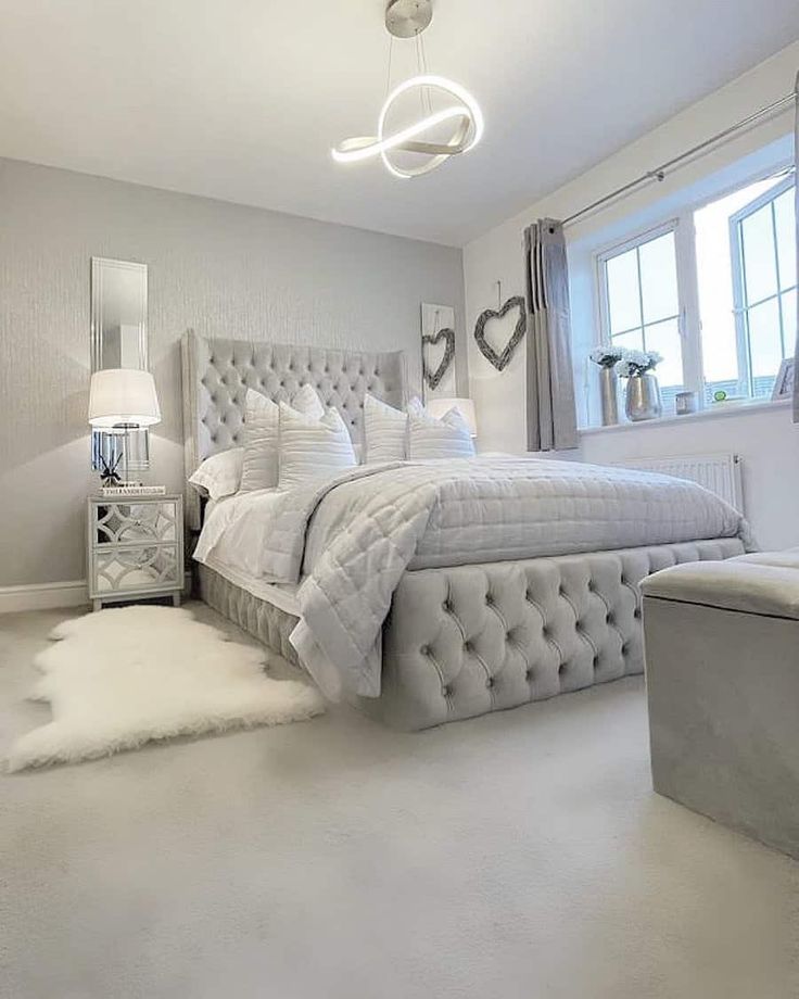 a bedroom with a large bed and white carpet