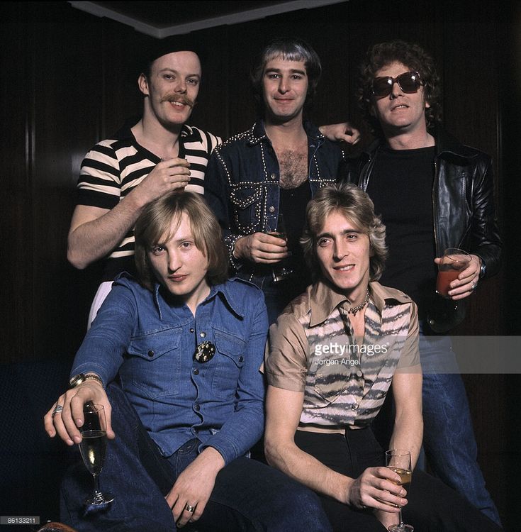 the rolling stones posing for a photo in their dressing room