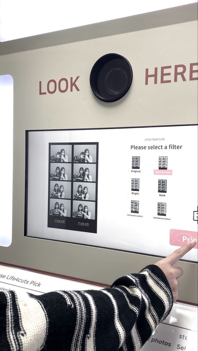 a person pointing at a display with pictures on it