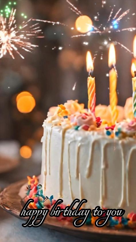 a birthday cake with lit candles on it