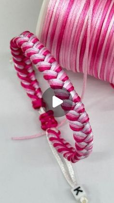 two spools of pink and white thread next to each other