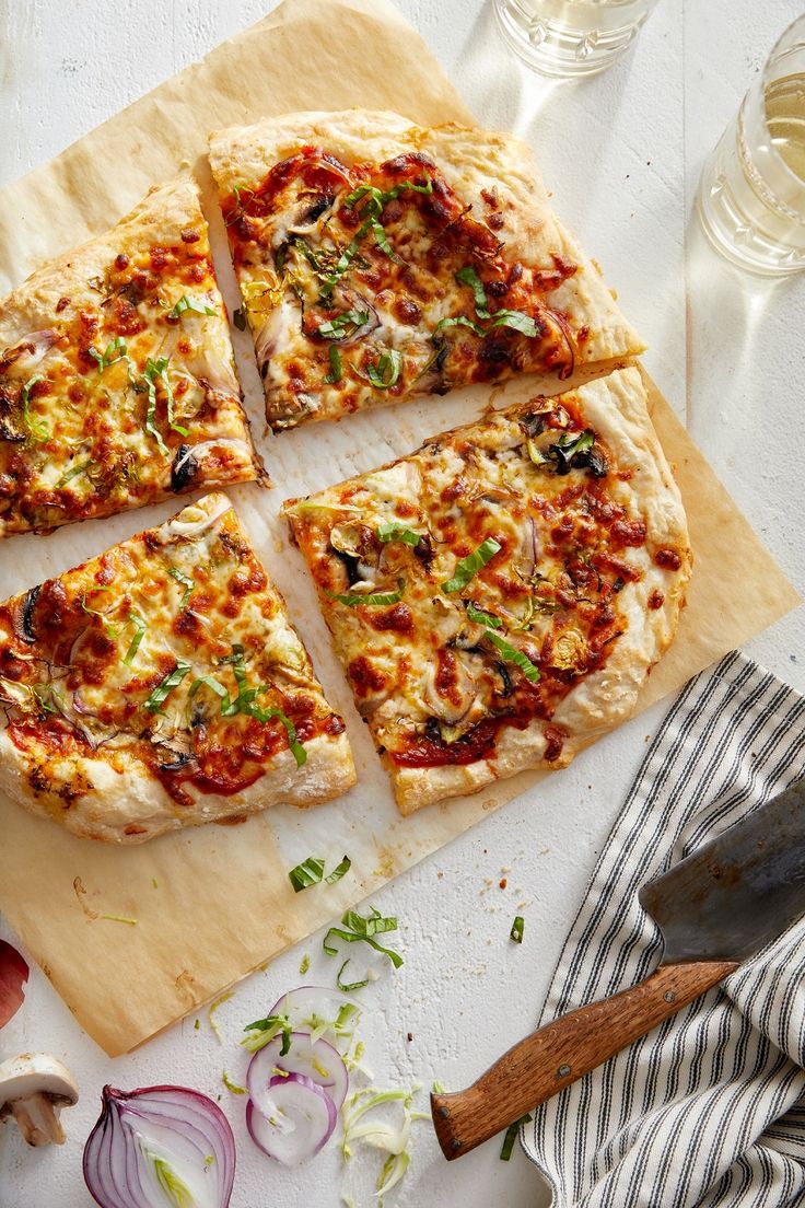 four slices of pizza sitting on top of a cutting board