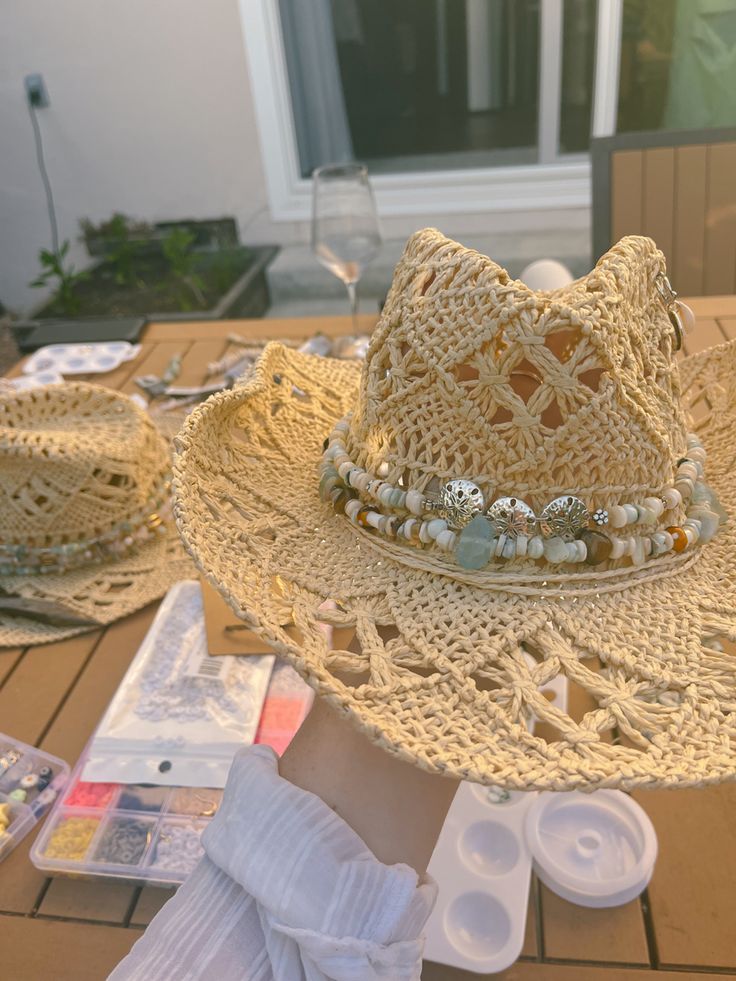 #coastal #coastalstyle #coastalcowgirl #coastalgrandaughter #cowgirl #cowgirlaesthetic #cowgirlhat #coastalcowboy #beading #crafting #summercraft #diy #summer #summervibes #summeraesthetic #beach Decorate Cowboy Hats Diy, Pink Cowgirl Party Aesthetic, Cowboy Hat With Beads, Coastal Cowgirl Dinner Party, Straw Hat Decorating Ideas, Cowgirl Hat Decorating Ideas, Cowboy Hat Decorated, Christine Core, Hat Making Ideas