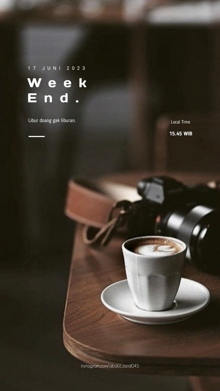 a coffee cup sitting on top of a wooden table next to a pair of binoculars