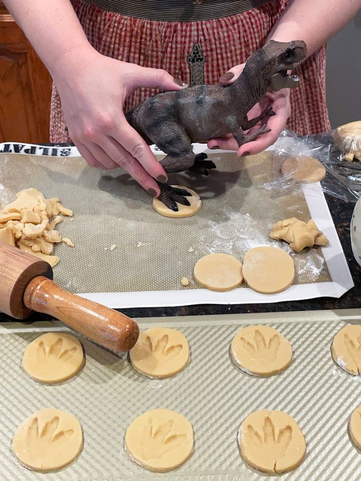 a person is making cookies on a table