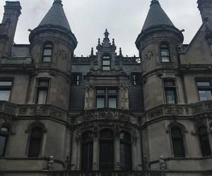 an old castle like building with many windows and towers on top of it's roof