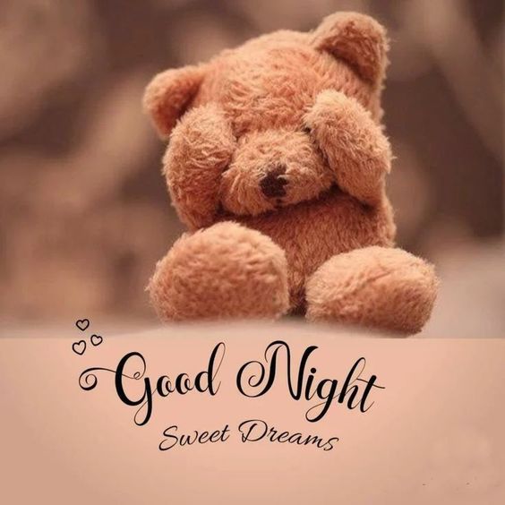 a brown teddy bear sitting on top of a table next to the words good night sweet dreams